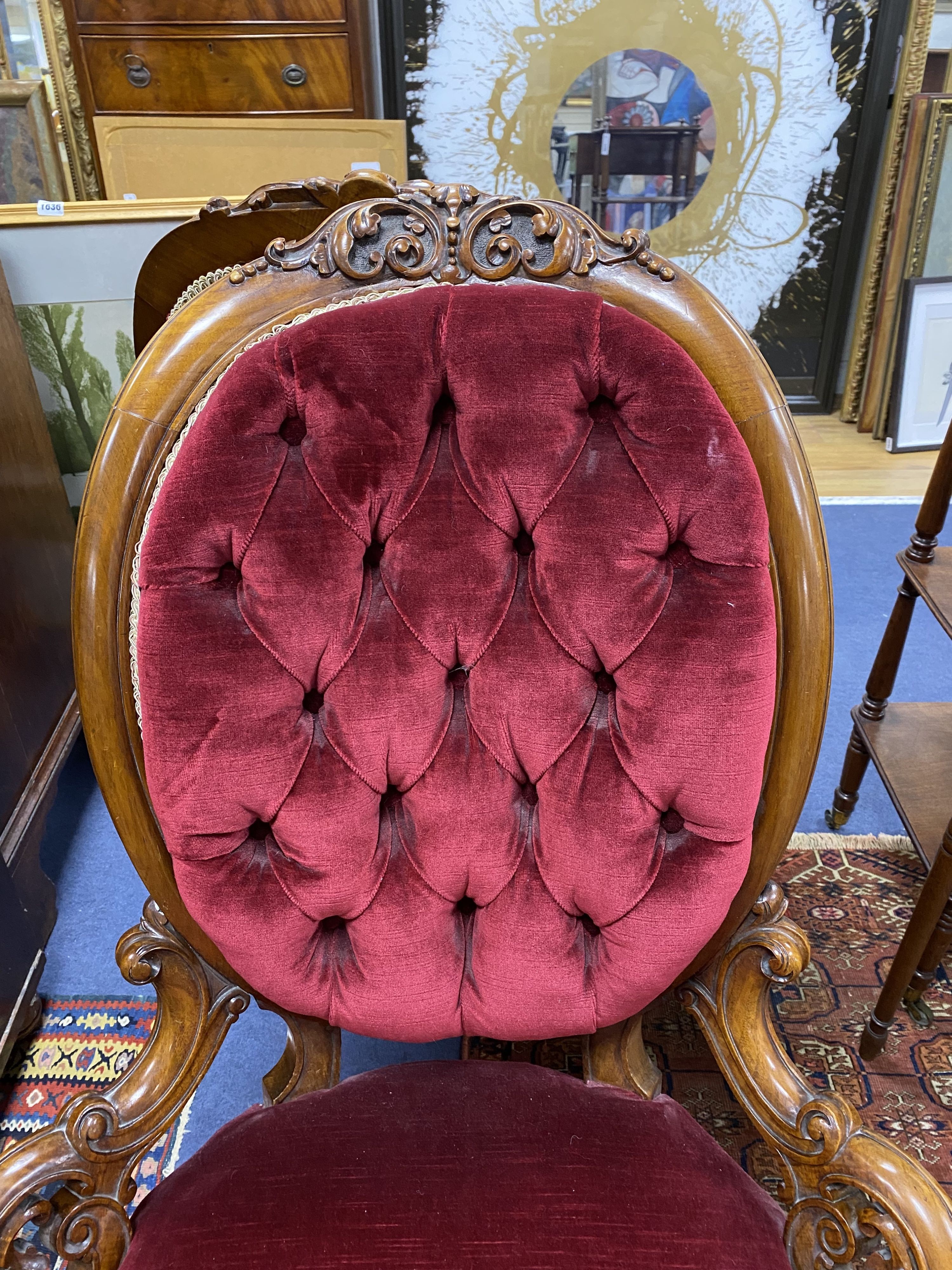 A Victorian carved walnut armchair and matching nursing chair